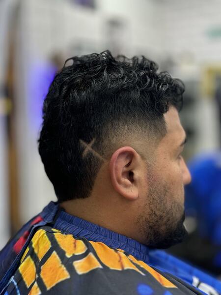 Curly fade with cross design